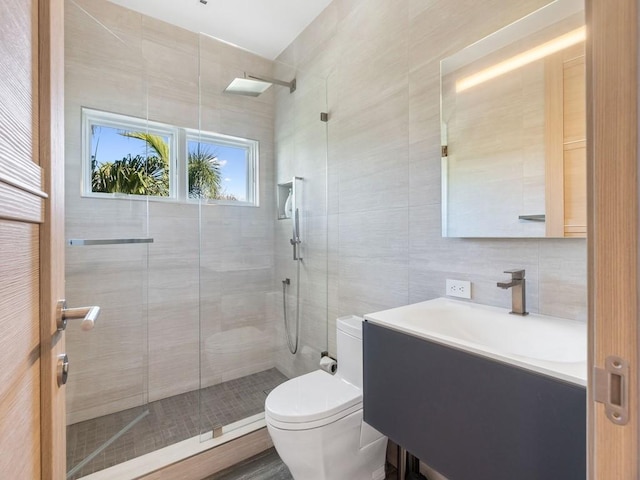 111 Mariner Beach Ln, Vero Beach, FL 32963 - bathroom featuring tile walls, tiled shower, and vanity