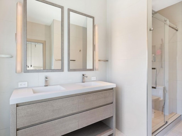 111 Mariner Beach Ln, Vero Beach, FL 32963 - bathroom featuring double vanity and a stall shower