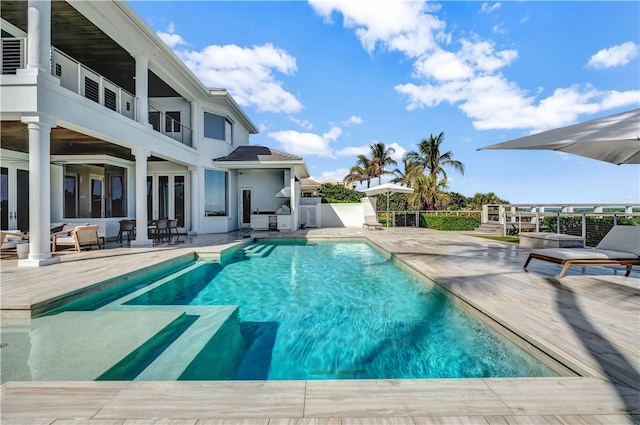 view of swimming pool featuring a patio area