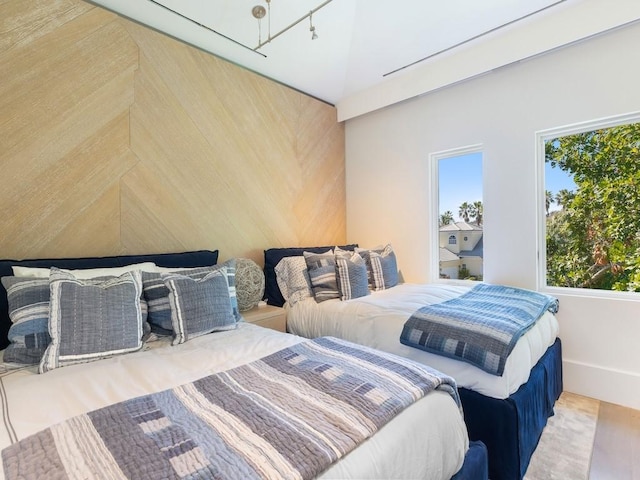 bedroom featuring hardwood / wood-style floors and multiple windows