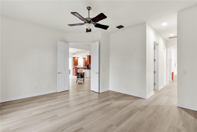 unfurnished room with light wood-type flooring and ceiling fan