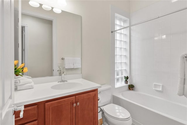 full bathroom with vanity, toilet, and tiled shower / bath