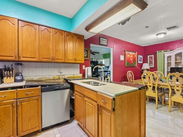 663 20th Pl SW, Vero Beach, FL 32962 - kitchen featuring stainless steel dishwasher, brown cabinets, backsplash, a textured ceiling, and light countertops