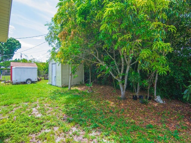 663 20th Pl SW, Vero Beach, FL 32962 - view of green lawn with a storage unit