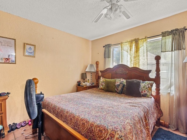 663 20th Pl SW, Vero Beach, FL 32962 - tiled bedroom featuring a textured ceiling, a textured wall, and ceiling fan