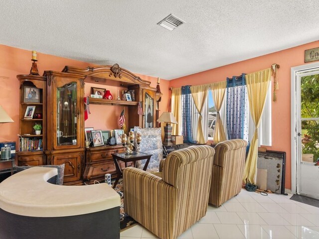 663 20th Pl SW, Vero Beach, FL 32962 - living room featuring a textured ceiling and light tile patterned flooring