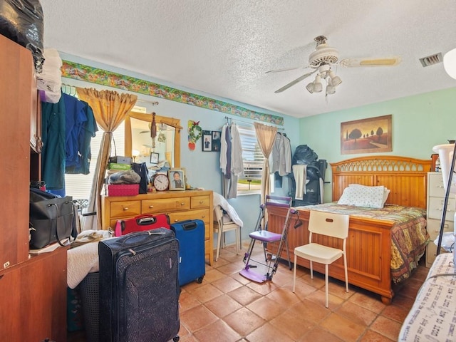 663 20th Pl SW, Vero Beach, FL 32962 - bedroom featuring a textured ceiling, a ceiling fan, and tile patterned flooring
