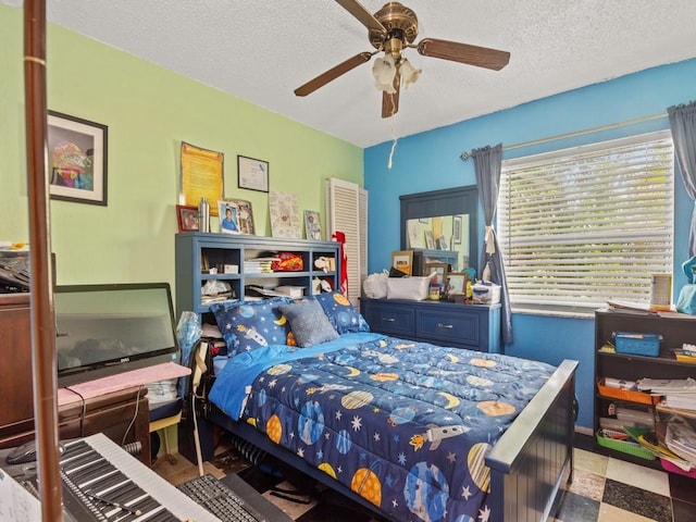 663 20th Pl SW, Vero Beach, FL 32962 - bedroom featuring tile patterned floors, ceiling fan, and a textured ceiling