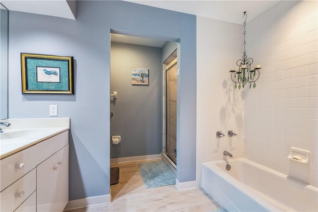 full bath with baseboards, a bathtub, a shower, and vanity