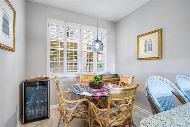 dining area with wine cooler and baseboards