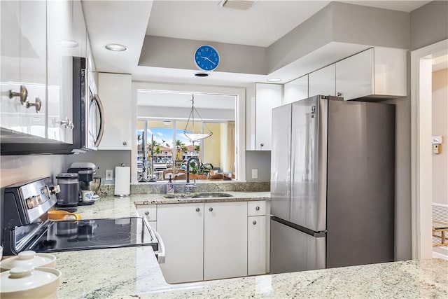 5520 N Harbor Village Dr Unit 203, Vero Beach, FL 32967 - kitchen featuring stainless steel appliances, white cabinetry, light stone counters, and recessed lighting