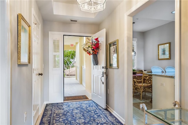 foyer with visible vents and baseboards