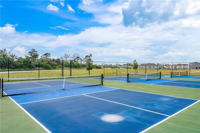 view of tennis court with fence