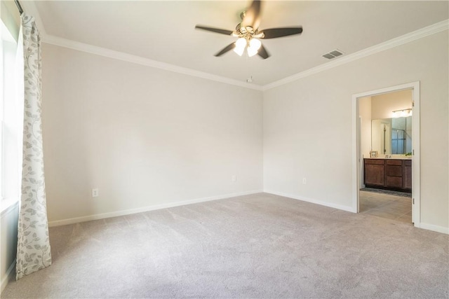 carpeted spare room with baseboards, visible vents, ceiling fan, and crown molding