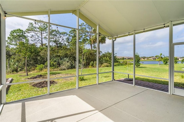 unfurnished sunroom with a water view and lofted ceiling