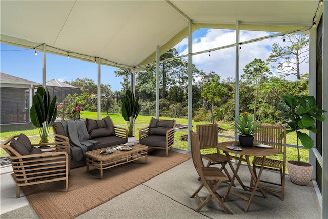 sunroom / solarium featuring lofted ceiling