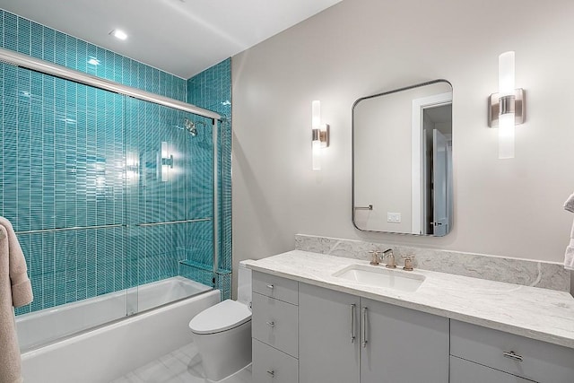 full bathroom with vanity, toilet, and combined bath / shower with glass door