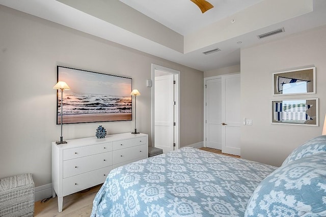 bedroom featuring ceiling fan and a raised ceiling