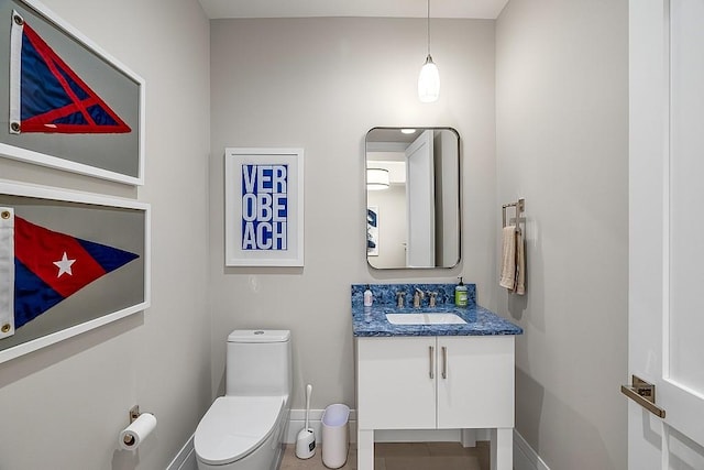 bathroom featuring vanity, tile patterned floors, and toilet