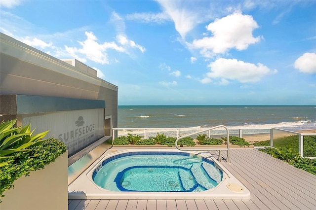 view of swimming pool with a view of the beach and a water view