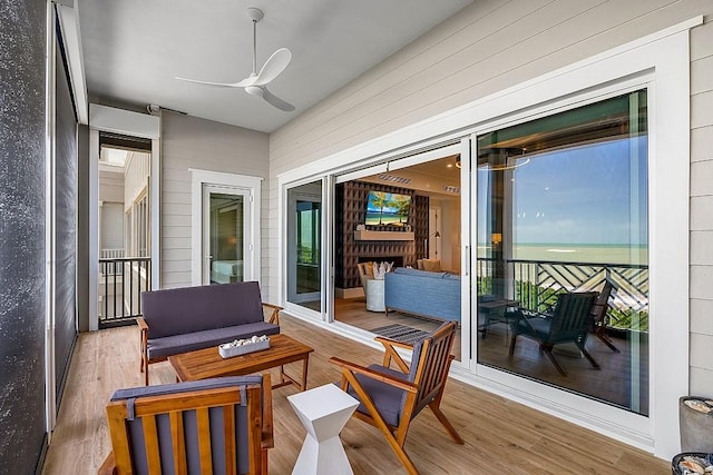 sunroom featuring ceiling fan