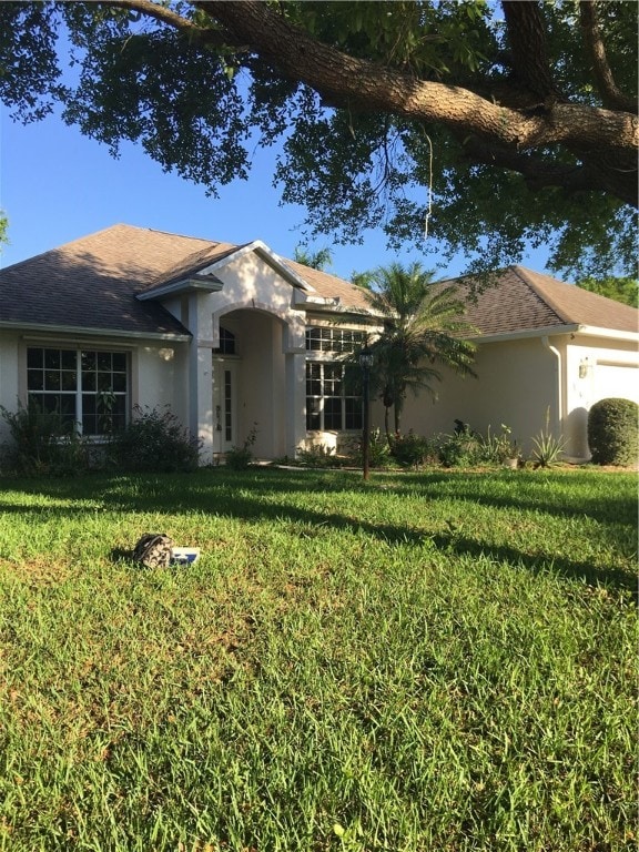 view of front of property with a garage and a front yard