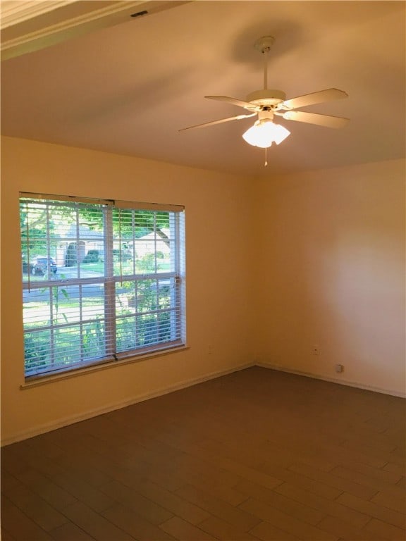 unfurnished room with ceiling fan and wood-type flooring