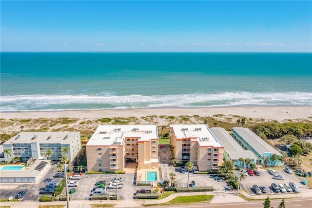 drone / aerial view featuring a view of the beach and a water view