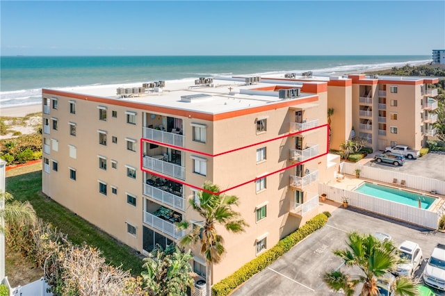 drone / aerial view with a beach view and a water view