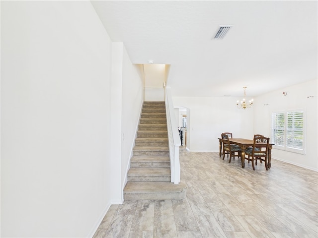 1458 Stonecrop St, Sebastian, FL 32958 - staircase with visible vents, arched walkways, baseboards, and a chandelier