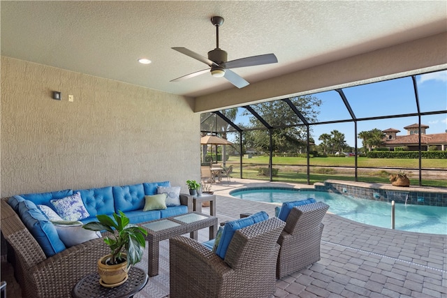 view of pool featuring outdoor lounge area, a patio area, ceiling fan, pool water feature, and a lanai