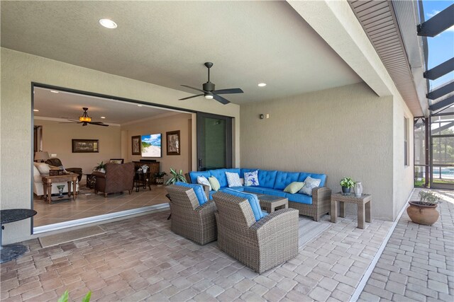 view of patio / terrace featuring an outdoor living space, a lanai, and ceiling fan