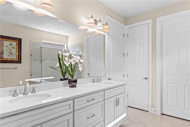 bathroom with walk in shower, vanity, and tile patterned floors