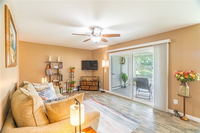 living room with wood-type flooring and ceiling fan