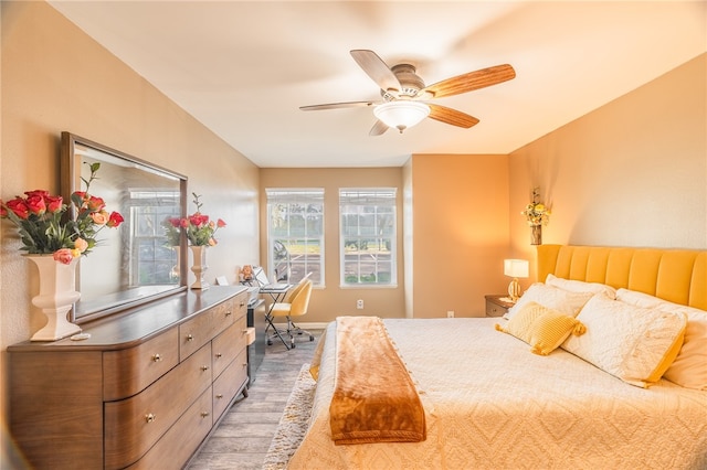 bedroom with hardwood / wood-style flooring and ceiling fan