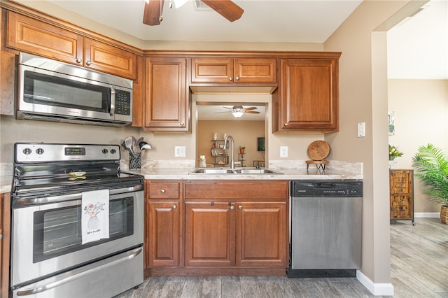 kitchen featuring sink, wood-type flooring, and stainless steel appliances