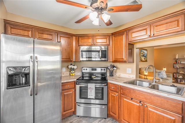 kitchen featuring ceiling fan, sink, light hardwood / wood-style flooring, and appliances with stainless steel finishes