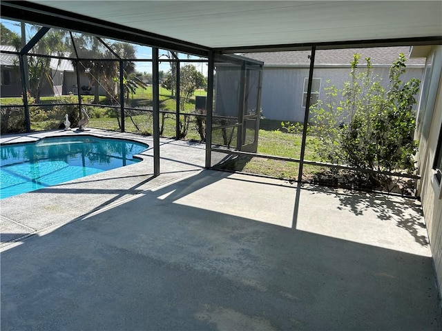 outdoor pool with glass enclosure and a patio area