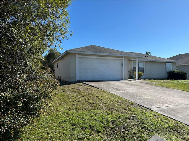 view of front facade with a front lawn, concrete driveway, and an attached garage