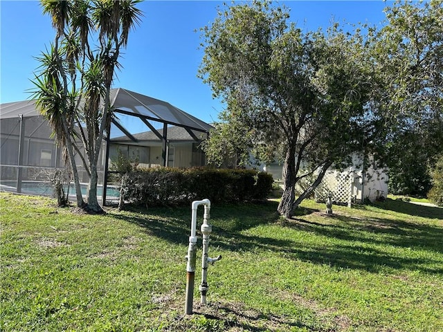 view of yard with a lanai and an outdoor pool