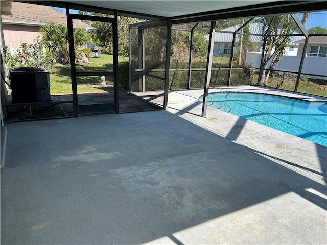 view of swimming pool featuring a fenced in pool, a lanai, a patio, and central AC unit