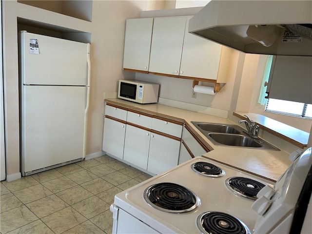 1080 Seamist Ln, Sebastian, FL 32958 - kitchen with white cabinets, under cabinet range hood, white appliances, and a sink