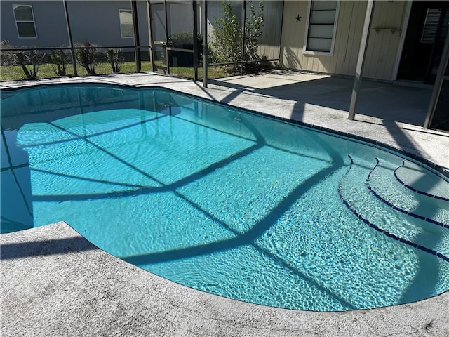 pool featuring a lanai and a patio area