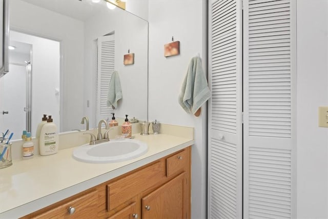 bathroom with a closet and vanity