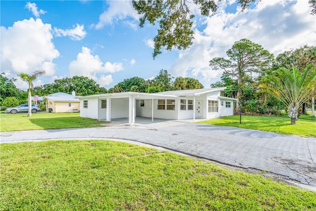 single story home with a front yard and a carport