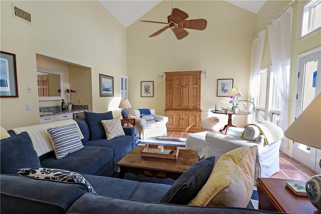 living room with high vaulted ceiling, ceiling fan, plenty of natural light, and light tile patterned floors