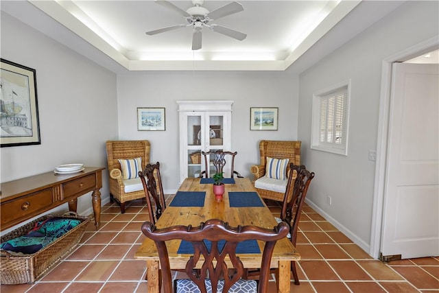 8367 Baytree Dr Unit 8367, Vero Beach, FL 32963 - dining room with a tray ceiling, a ceiling fan, and tile patterned floors