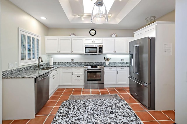 8367 Baytree Dr Unit 8367, Vero Beach, FL 32963 - kitchen featuring appliances with stainless steel finishes, stone countertops, dark tile patterned flooring, white cabinets, and recessed lighting