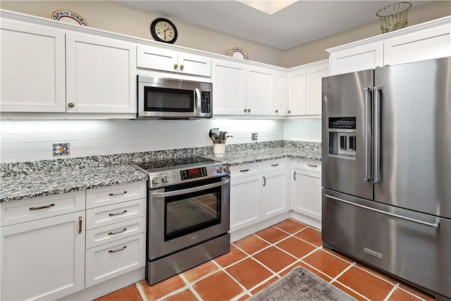 8367 Baytree Dr Unit 8367, Vero Beach, FL 32963 - kitchen with appliances with stainless steel finishes, white cabinets, and tasteful backsplash