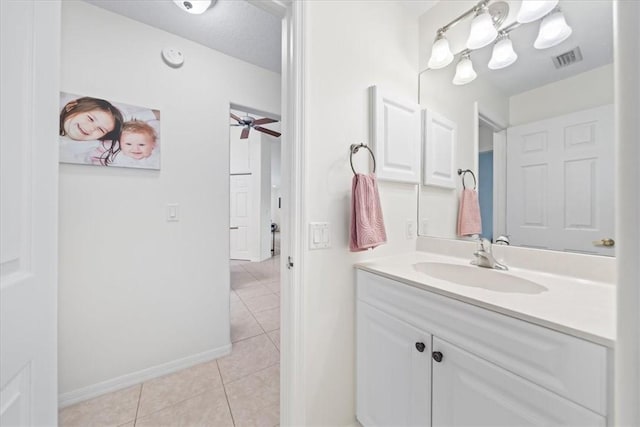 bathroom with a textured ceiling, ceiling fan, tile patterned flooring, and vanity